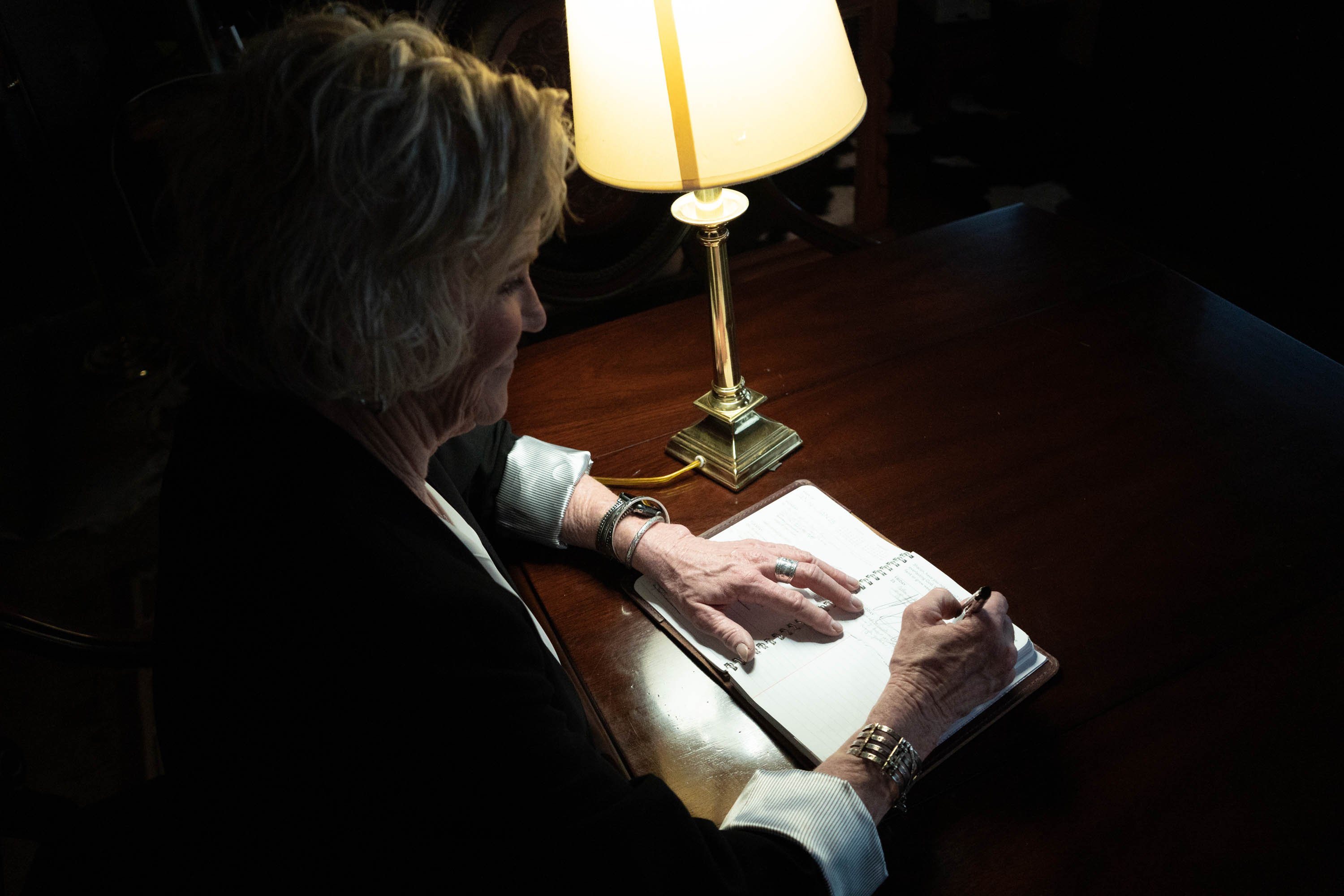 Sharon Beach writing by lamplight